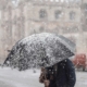 man walking through a snow storm