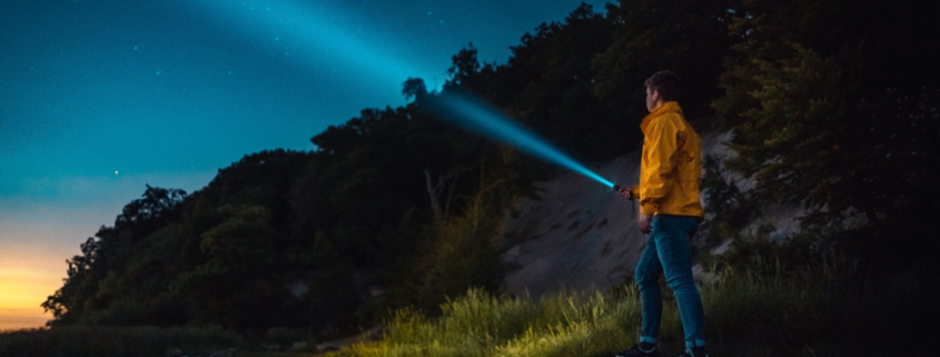 flashlight at night looking at the stars along the river